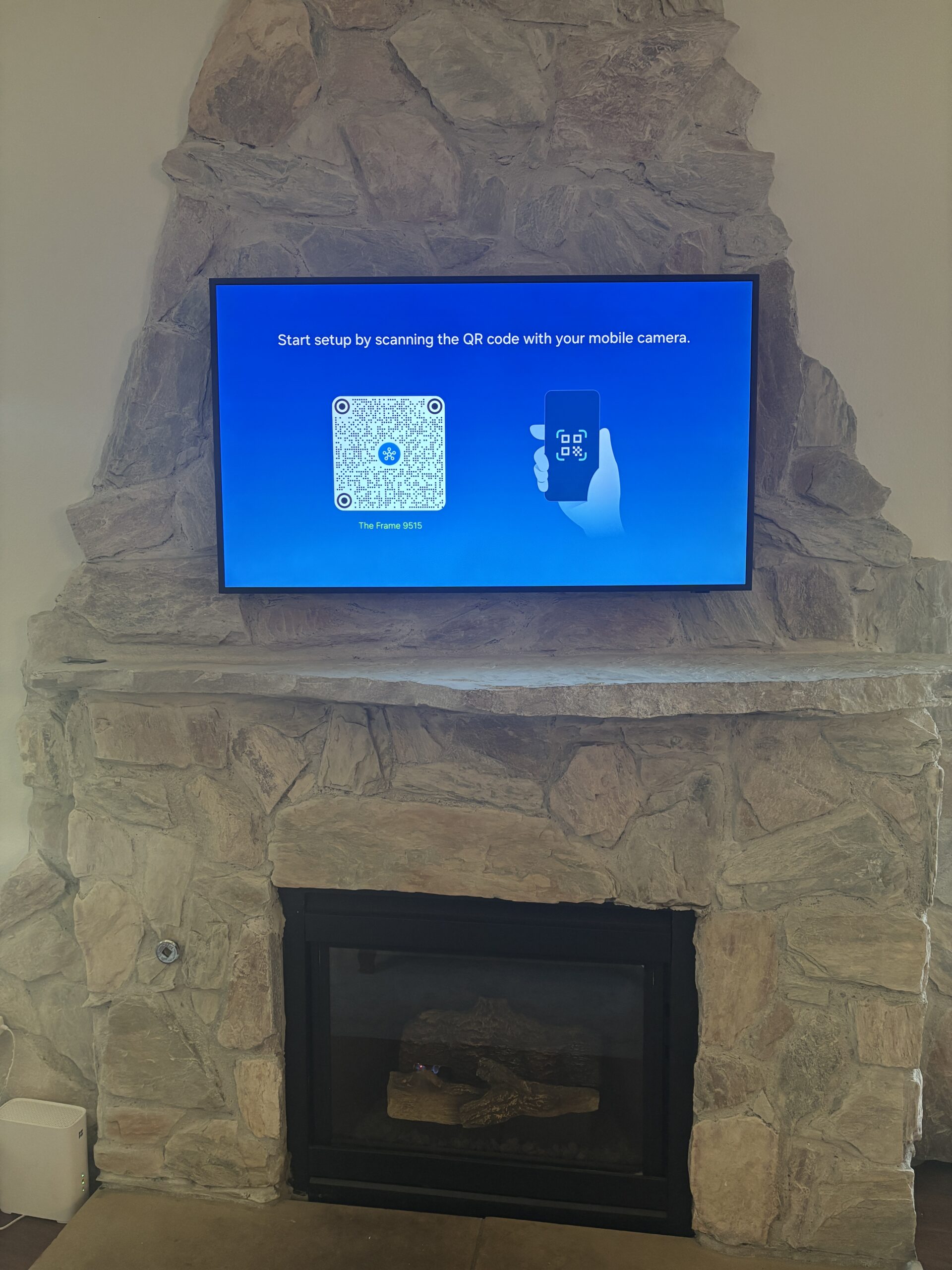 50 inch Samsung Frame TV over stone fireplace with cord concealment in Cedar Park TX