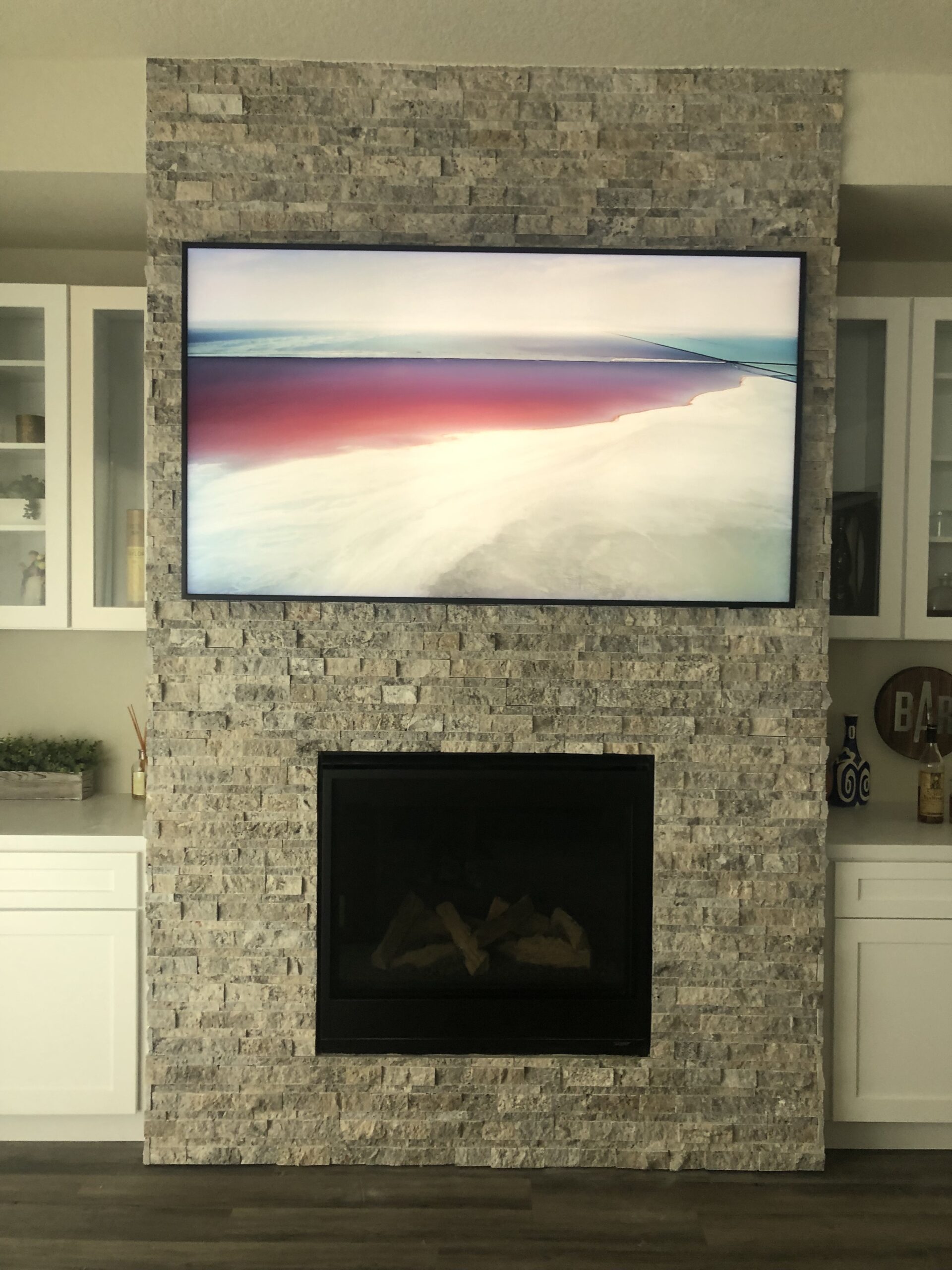 85 inch Samsung Frame TV mounted over tile fireplace in Lakeway TX home