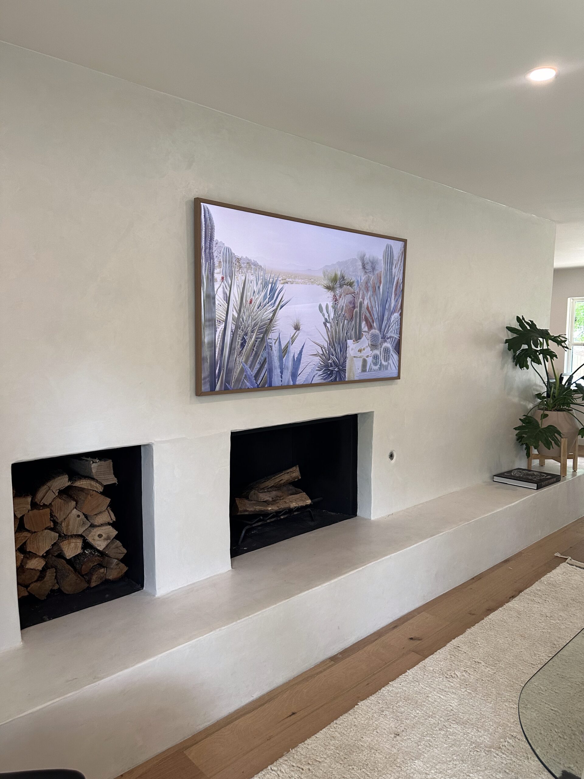 75 inch Samsung Frame TV mounted over stucco fireplace in Dripping Springs TX