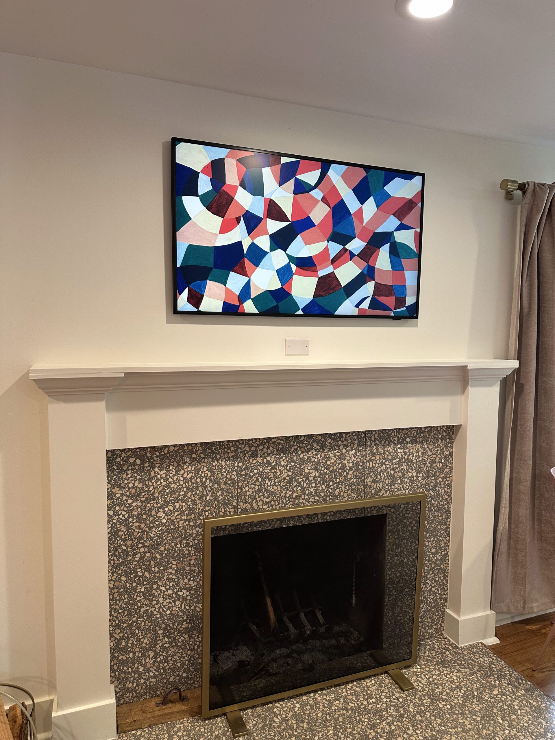 50 inch Samsung Frame TV over fireplace with recessed wall box cord concealment in Mueller Austin
